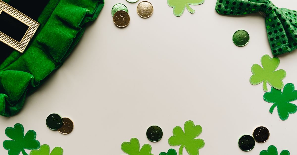 St. Patrick's Day themed scene with green shamrocks, coins, and a hat for good luck.